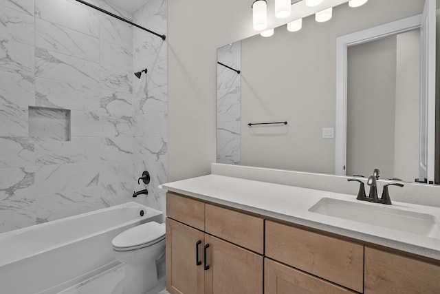 full bathroom with vanity, tiled shower / bath combo, and toilet