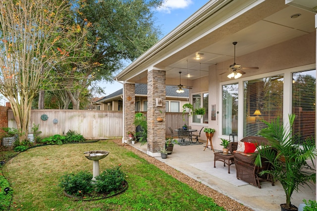 view of yard featuring ceiling fan and a patio area