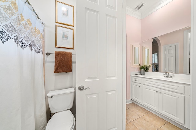 bathroom with tile patterned flooring, vanity, crown molding, and toilet