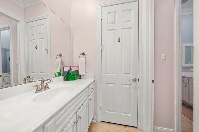 bathroom with crown molding, vanity, and tile patterned flooring