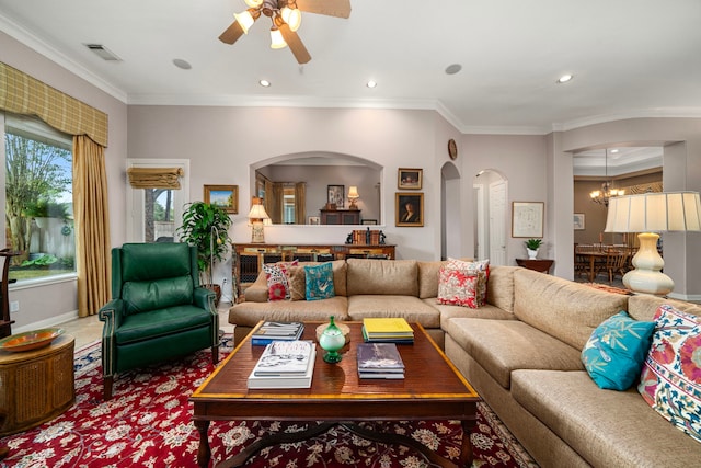 living room featuring crown molding and ceiling fan with notable chandelier