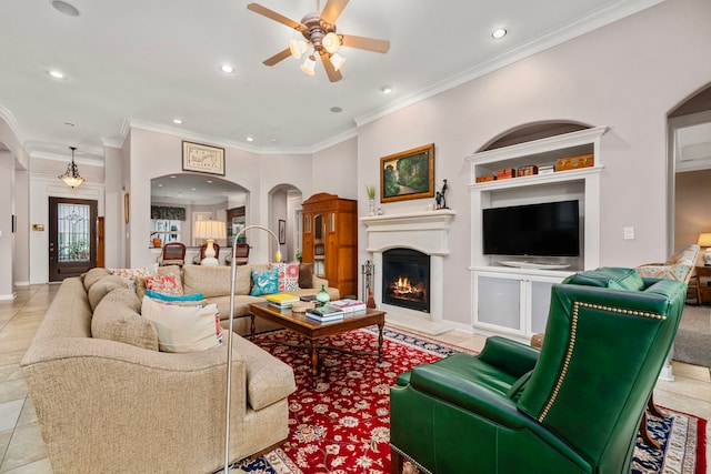 living room with ornamental molding, light tile patterned floors, and ceiling fan