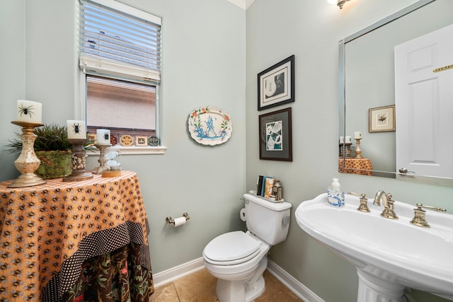 bathroom with tile patterned flooring, sink, and toilet