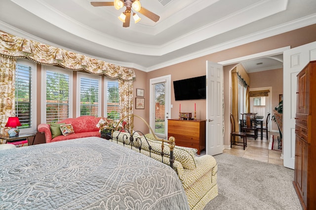 bedroom with crown molding, light colored carpet, a raised ceiling, and ceiling fan