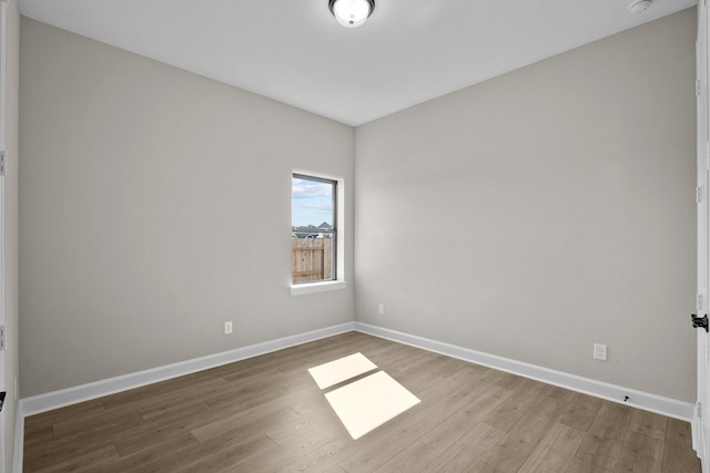 spare room featuring wood-type flooring