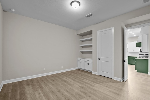 unfurnished bedroom featuring light hardwood / wood-style flooring and a textured ceiling