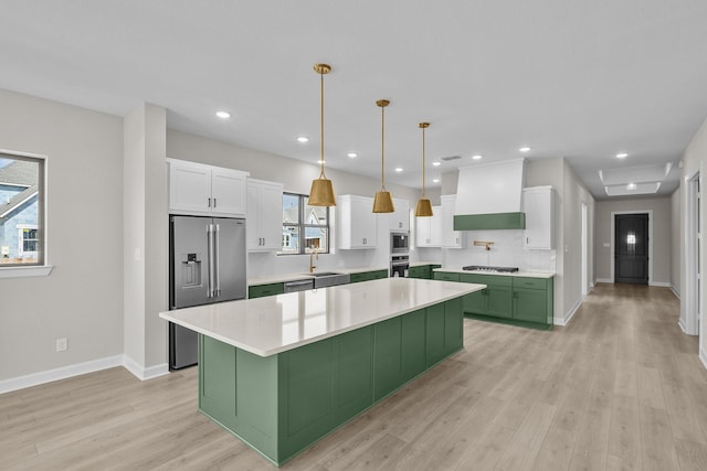 kitchen featuring white cabinetry, sink, stainless steel appliances, and custom range hood