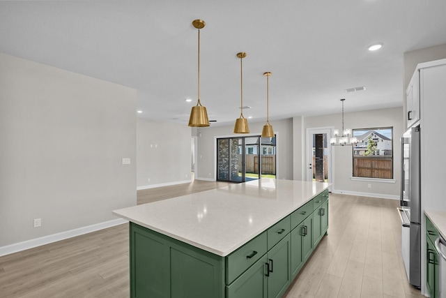 kitchen featuring pendant lighting, green cabinetry, an inviting chandelier, and a kitchen island