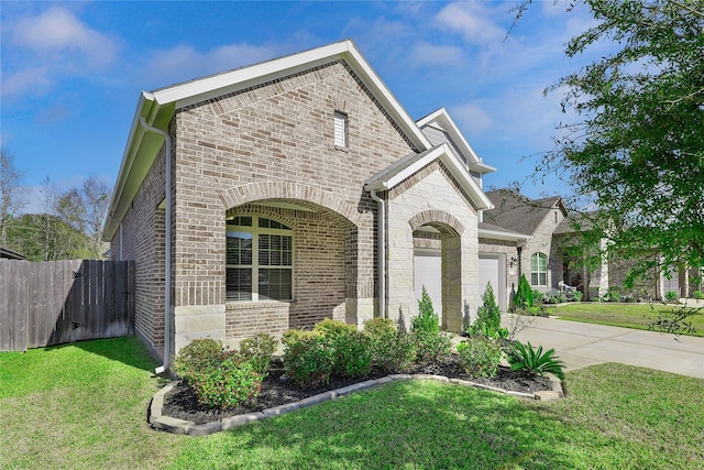 view of front of property with a garage and a front lawn