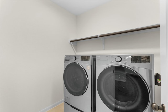 clothes washing area featuring washer and dryer