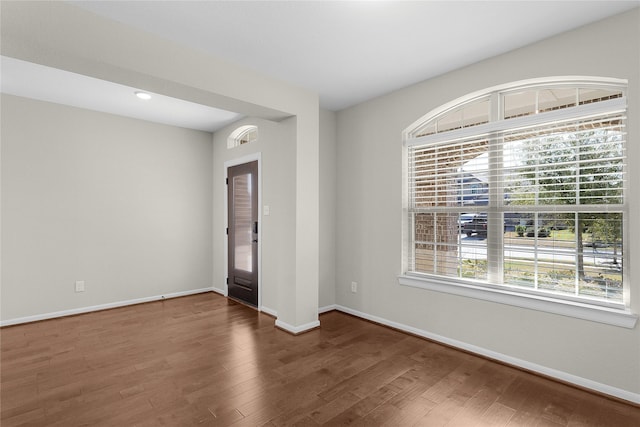 unfurnished room featuring dark wood-type flooring