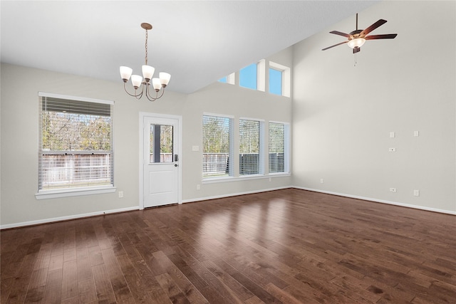 interior space with dark wood-type flooring and ceiling fan with notable chandelier