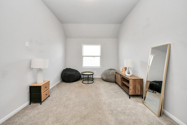 living area with vaulted ceiling and light carpet