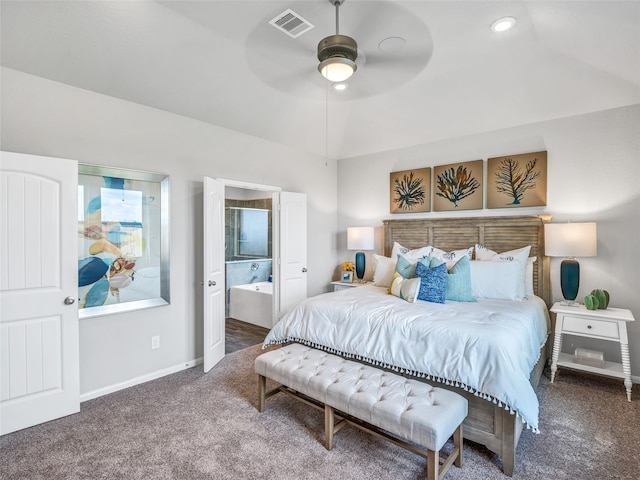 carpeted bedroom with ceiling fan, ensuite bathroom, and lofted ceiling