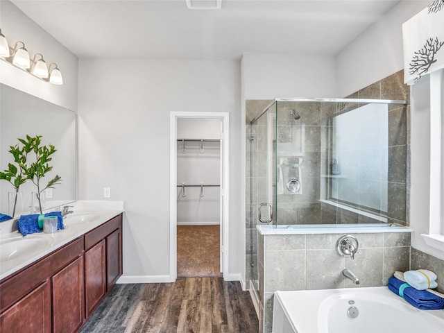 bathroom featuring vanity, hardwood / wood-style floors, and shower with separate bathtub