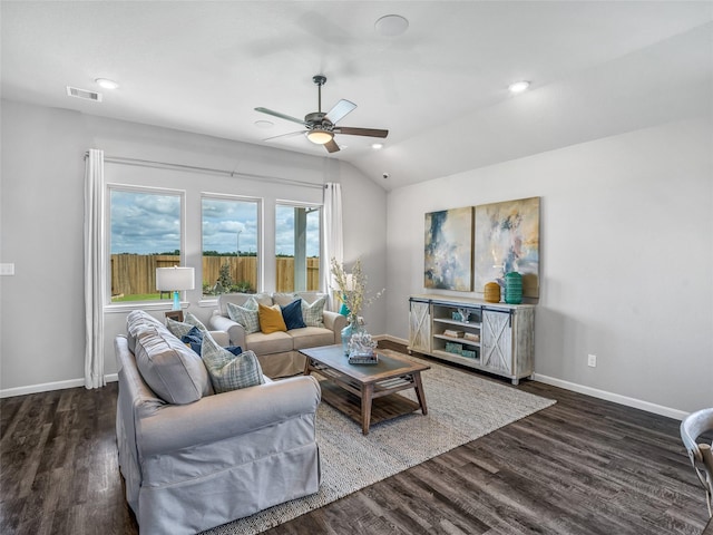 living area with vaulted ceiling, wood finished floors, visible vents, and baseboards