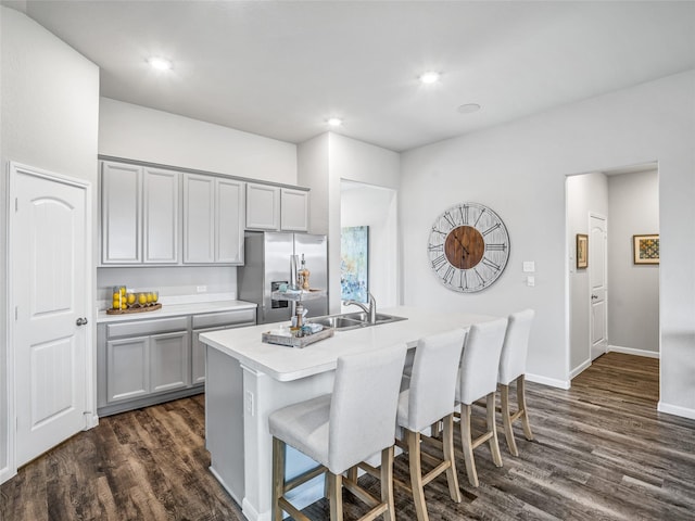 27014 Costa Creek Dr, Katy, TX 77493 - kitchen featuring stainless steel fridge with ice dispenser, gray cabinetry, a kitchen breakfast bar, dark wood-style flooring, and recessed lighting