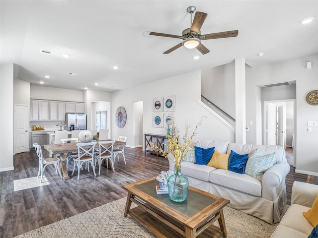 living room with dark wood-style floors and recessed lighting