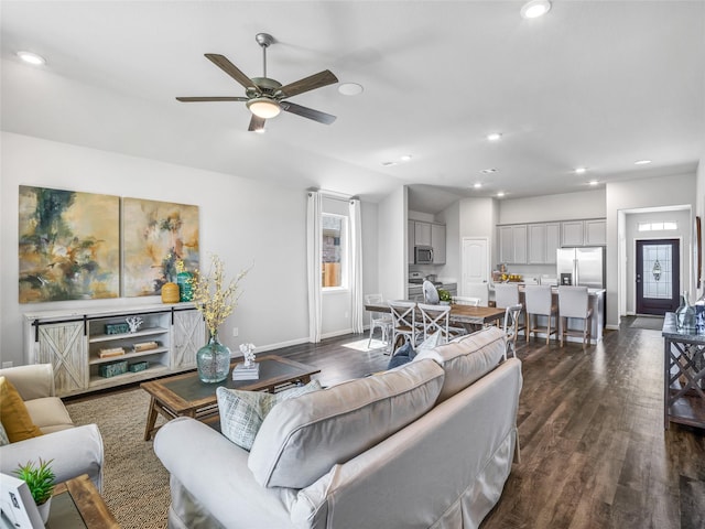 living area with dark wood-style flooring, recessed lighting, lofted ceiling, a ceiling fan, and baseboards