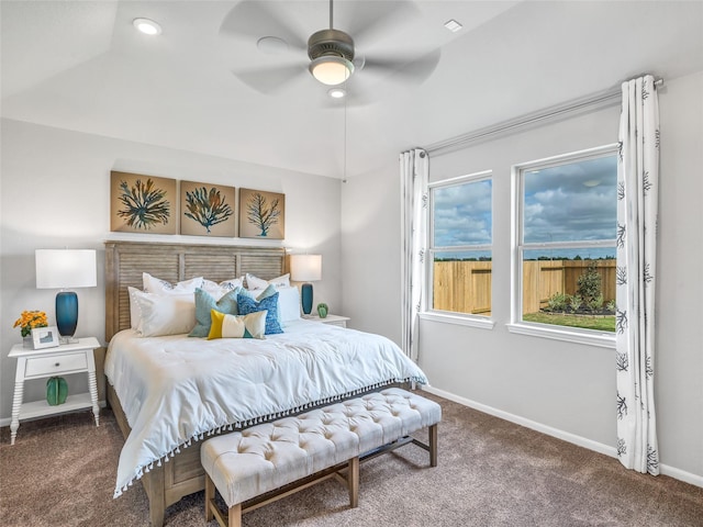 carpeted bedroom with ceiling fan and baseboards