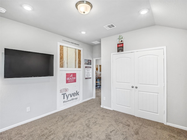 unfurnished bedroom with carpet floors, recessed lighting, a closet, visible vents, and vaulted ceiling