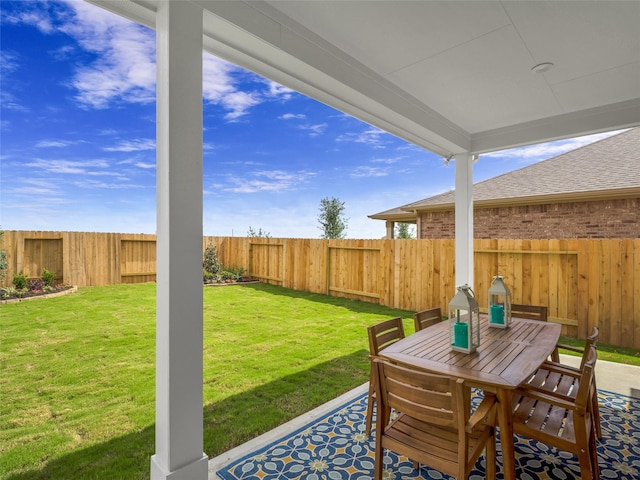 view of patio featuring a fenced backyard and outdoor dining area