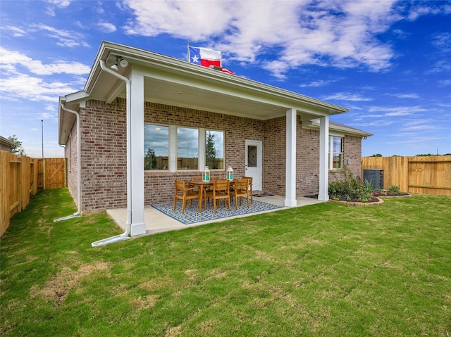 27014 Costa Creek Dr, Katy, TX 77493 - rear view of house with brick siding, a patio area, central AC, and a chimney