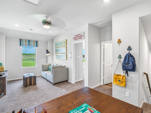 living area with a ceiling fan, carpet, visible vents, and baseboards