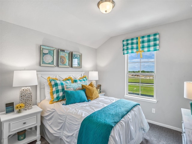 carpeted bedroom with baseboards and vaulted ceiling