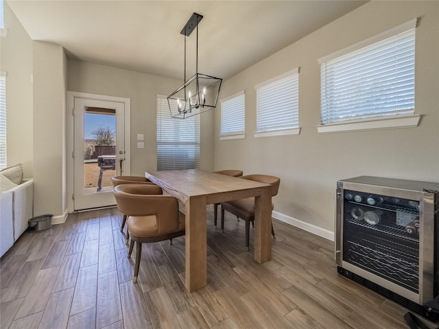 dining space featuring an inviting chandelier, wood-type flooring, and heating unit