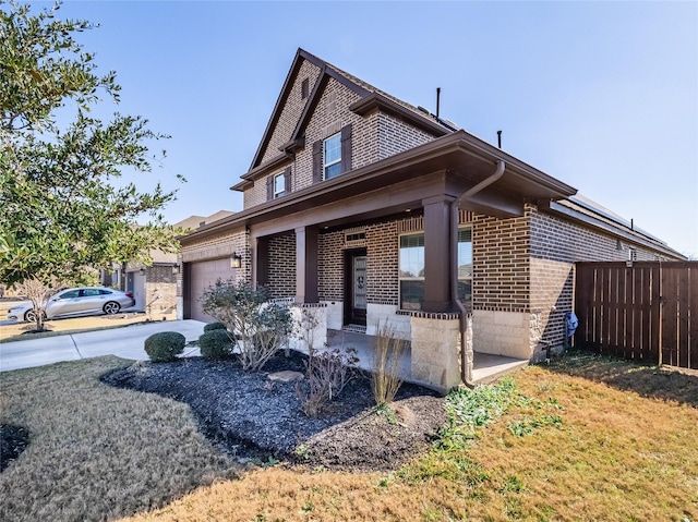 view of front facade with a garage, a front yard, and covered porch