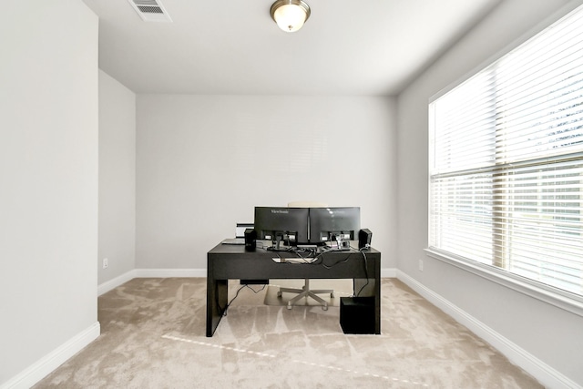 office area featuring light carpet