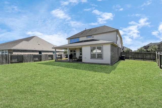 rear view of property with a patio area and a lawn