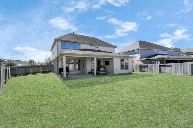 back of house featuring a yard and a patio area