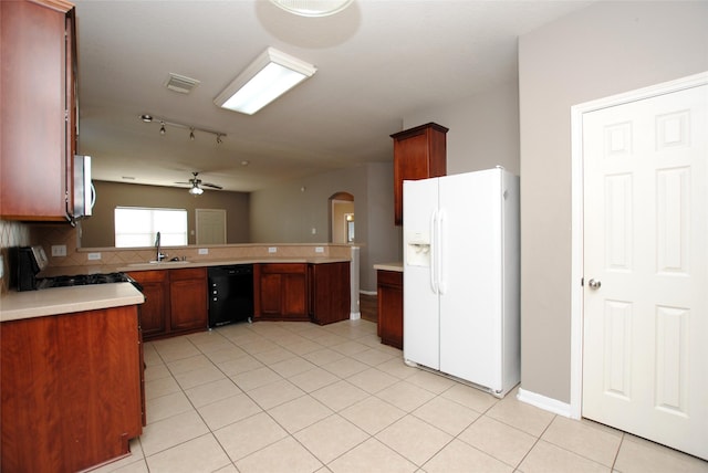 kitchen with black dishwasher, kitchen peninsula, white fridge with ice dispenser, decorative backsplash, and stove