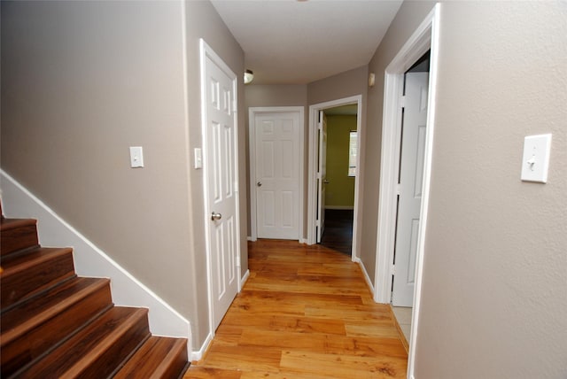 corridor with light wood-type flooring