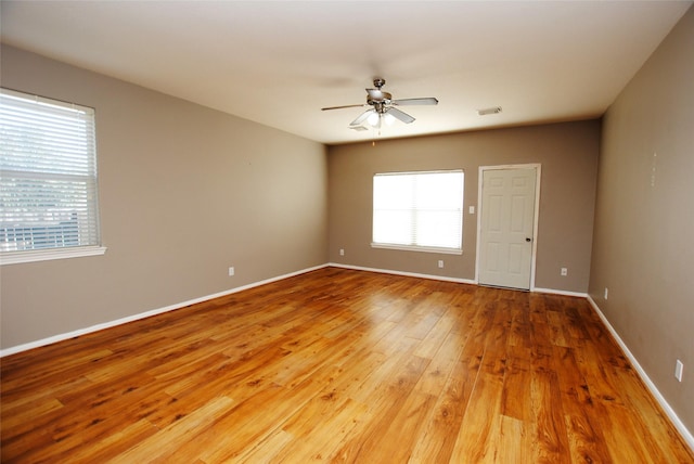 empty room with hardwood / wood-style flooring and ceiling fan