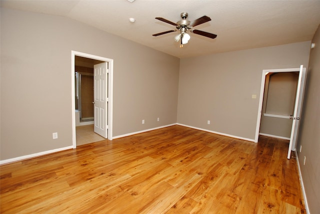 unfurnished bedroom with hardwood / wood-style floors, ensuite bath, and ceiling fan