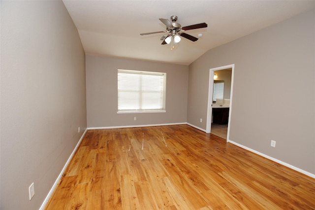 empty room with lofted ceiling, ceiling fan, and light hardwood / wood-style flooring