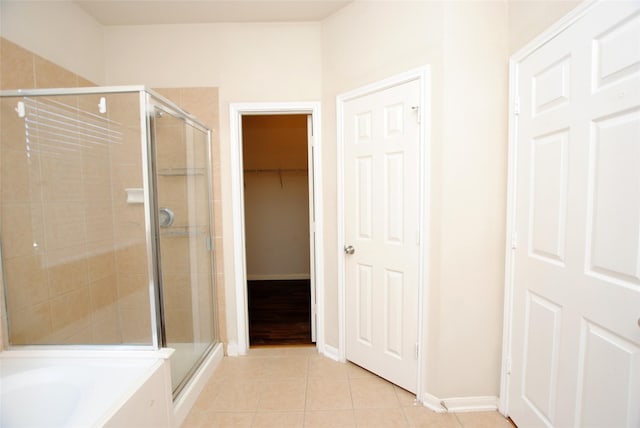 bathroom with independent shower and bath and tile patterned floors