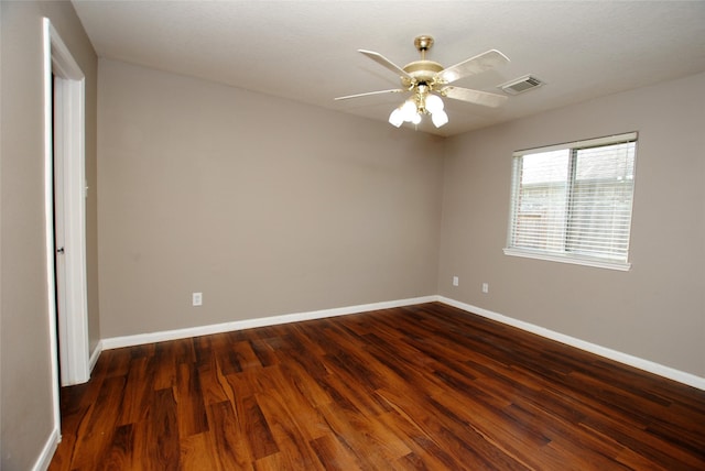 unfurnished room featuring dark wood-type flooring and ceiling fan