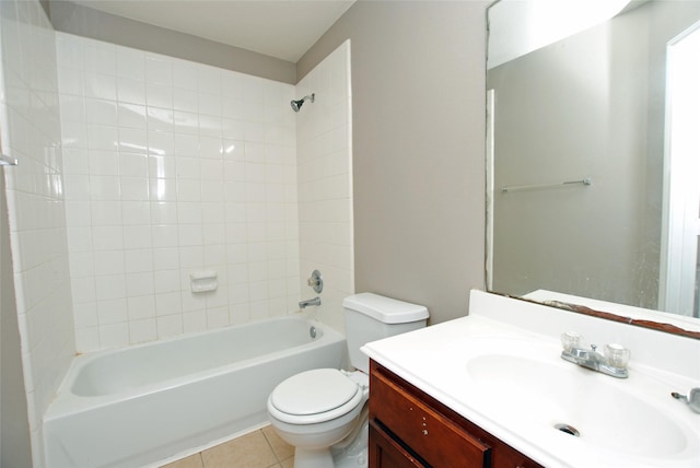 full bathroom with tile patterned flooring, tiled shower / bath, vanity, and toilet