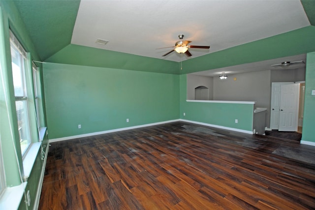 spare room featuring dark hardwood / wood-style flooring, vaulted ceiling, and ceiling fan