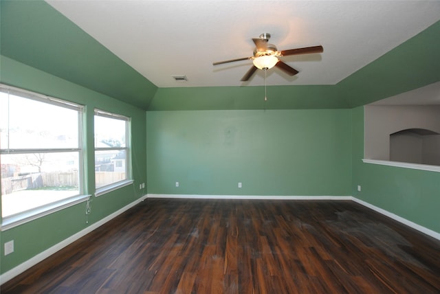 unfurnished room with dark hardwood / wood-style flooring, vaulted ceiling, and ceiling fan