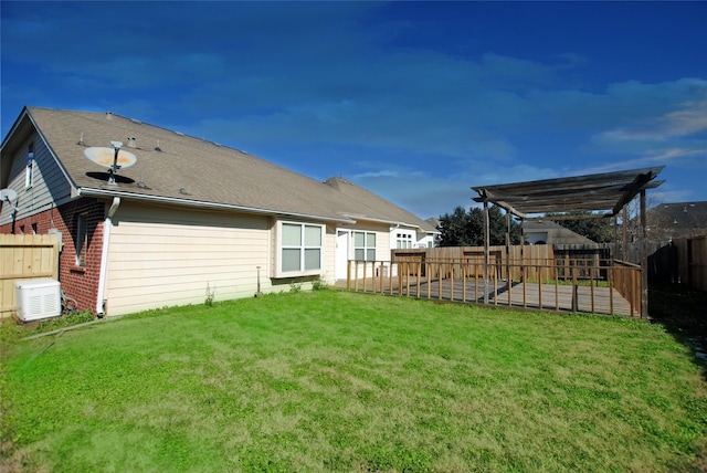 rear view of property with a yard and a pergola