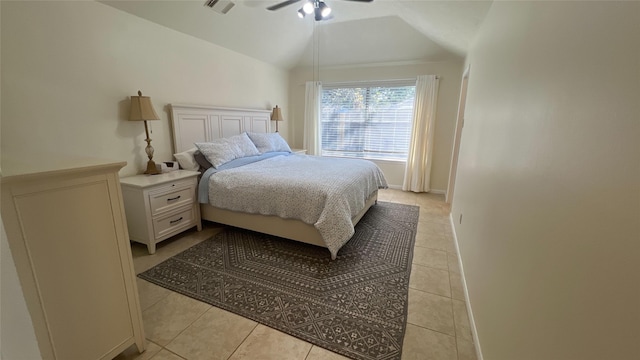 bedroom featuring vaulted ceiling, ceiling fan, light tile patterned floors, and baseboards