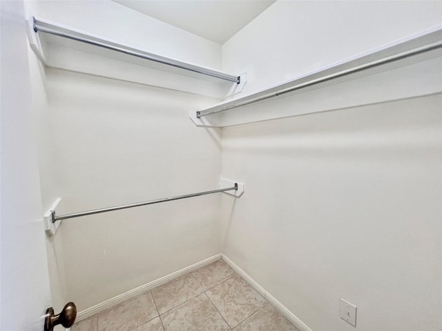 spacious closet with light tile patterned flooring