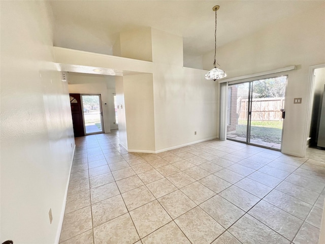 unfurnished room featuring a healthy amount of sunlight, a high ceiling, and light tile patterned floors