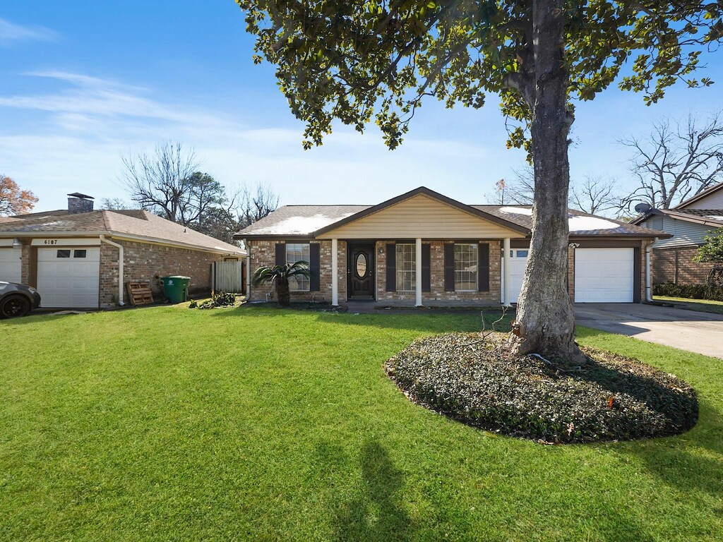 4111 R V Mayfield Dr, Houston, TX 77088 - single story home with a porch, a garage, and a front lawn
