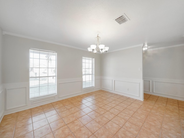 unfurnished room featuring light tile patterned flooring, ornamental molding, and an inviting chandelier